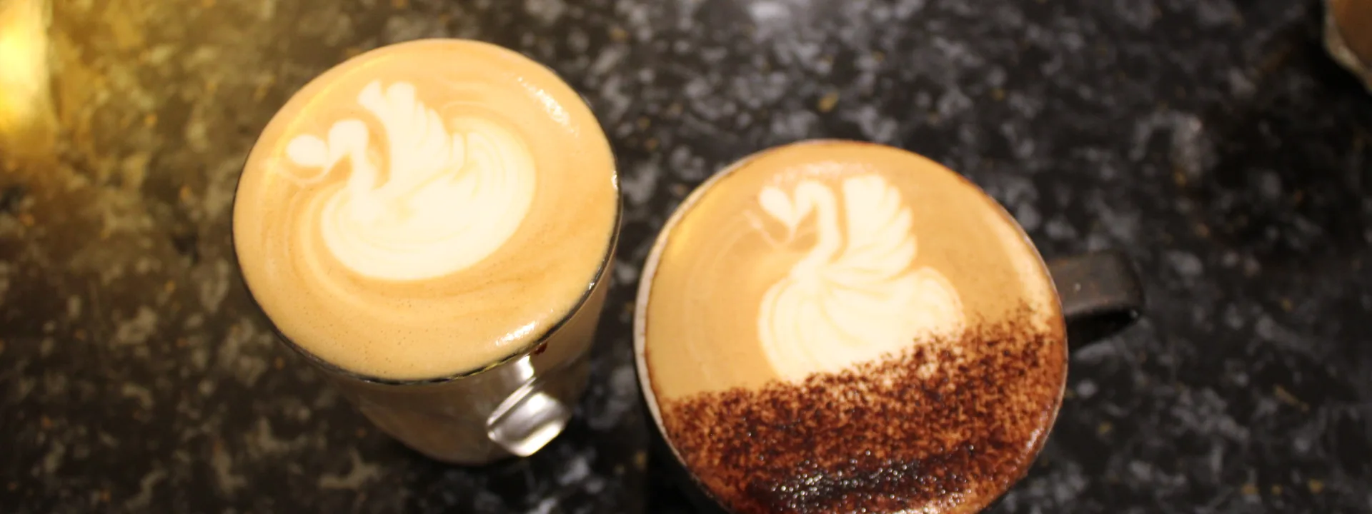 Two coffees with latte art on the counter at Ream Cafe