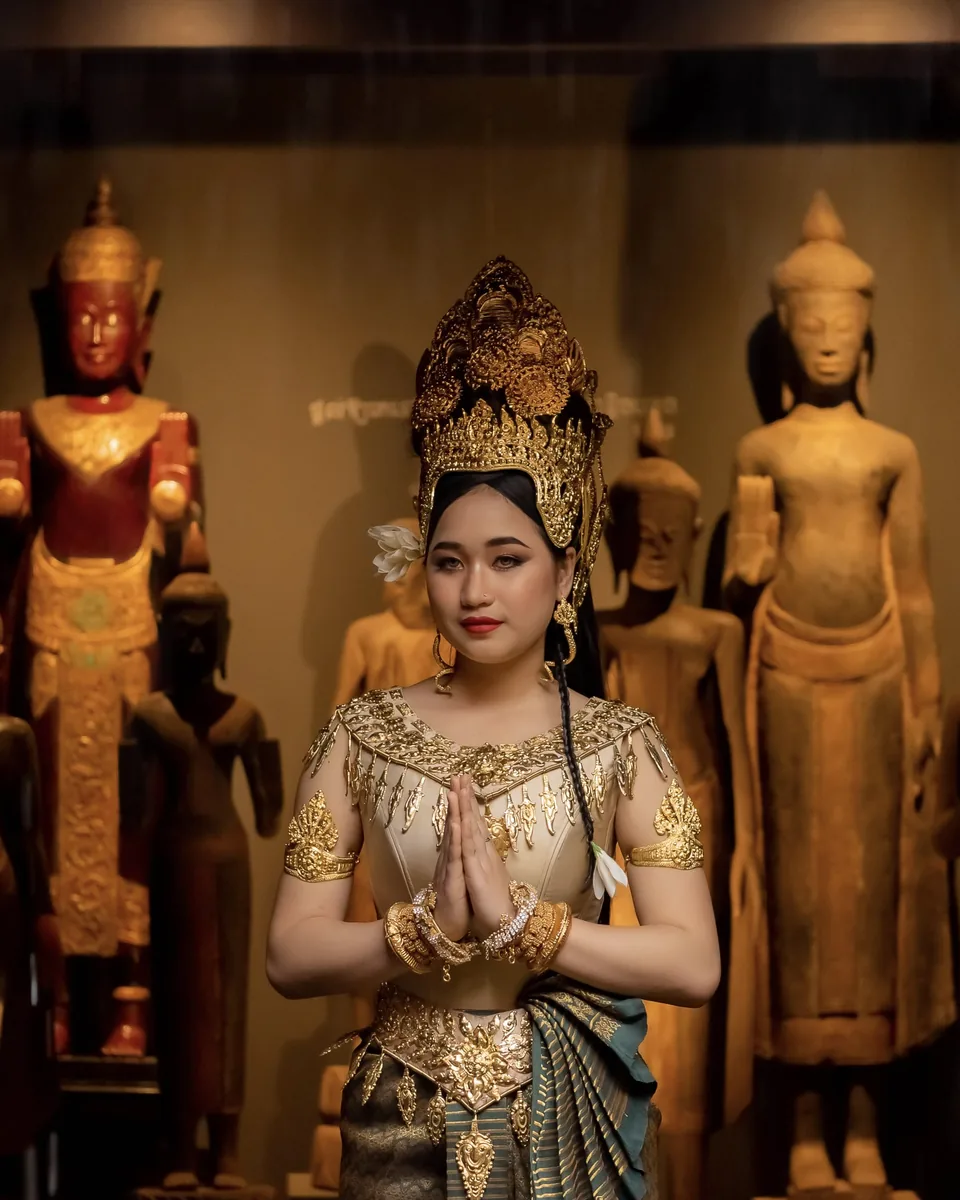 Siv in traditional Khmer dress, hands joined in a sampeah